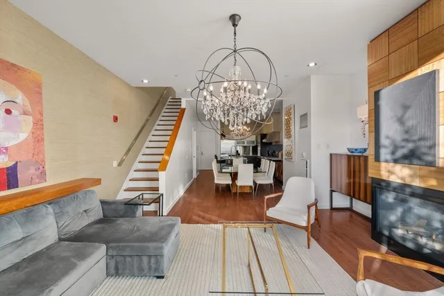 a living room with furniture and a chandelier
