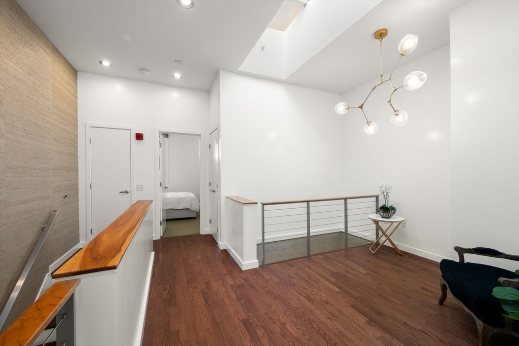 88 Kingston Street, Unit PH7C Boston, MA 02111 - Photo 18 of 31 a view of hallway with wooden floor and fan