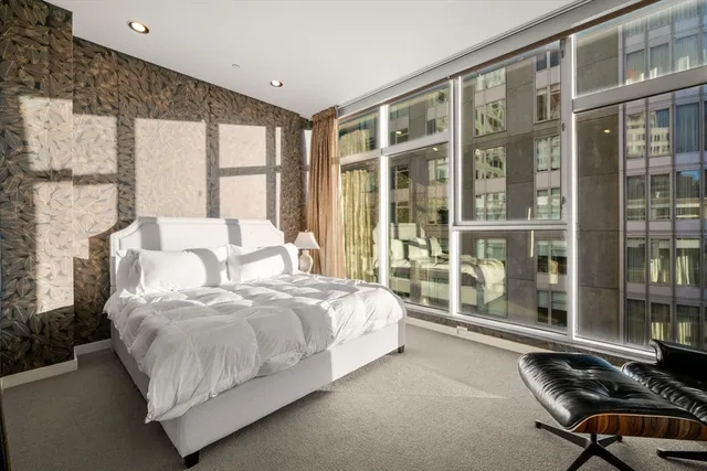 a bedroom with a large bed and a large window