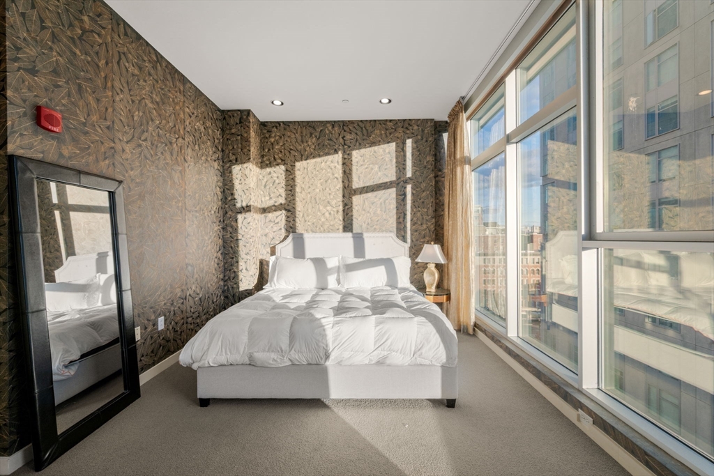 88 Kingston Street, Unit PH7C Boston, MA 02111 - Photo 20 of 31 a bedroom with a bed and large window