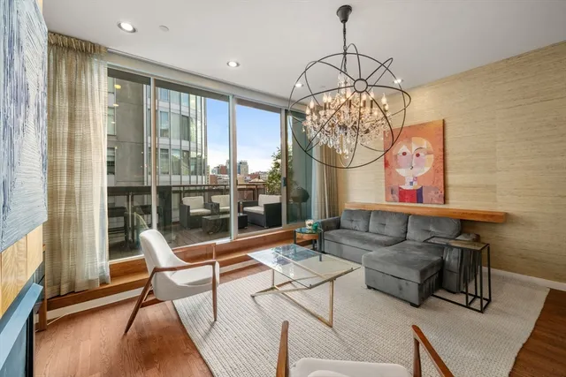 a living room with furniture and a chandelier