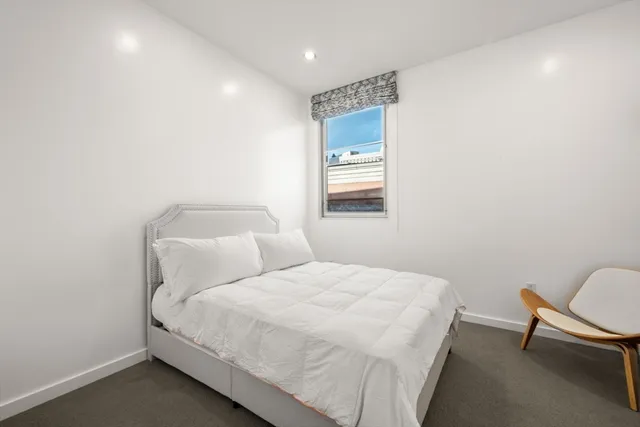 a bedroom with a bed and a chair