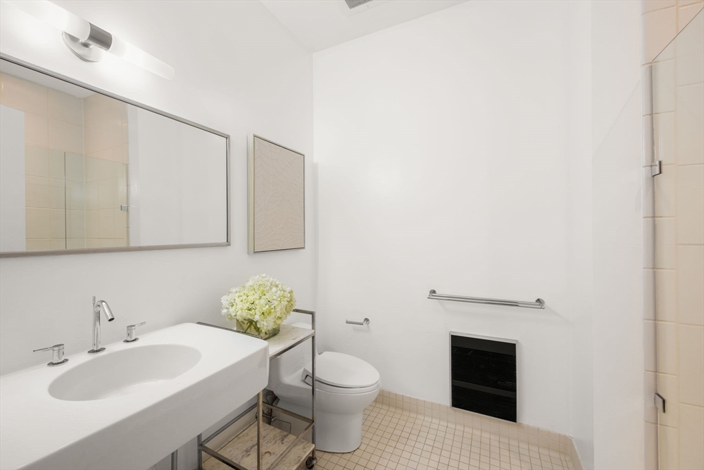 88 Kingston Street, Unit PH7C Boston, MA 02111 - Photo 26 of 31 a bathroom with a sink toilet and vanity