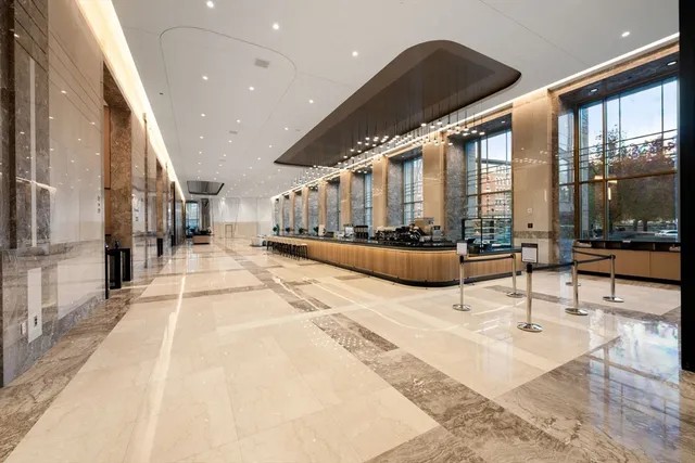 a lobby with furniture and floor to ceiling window