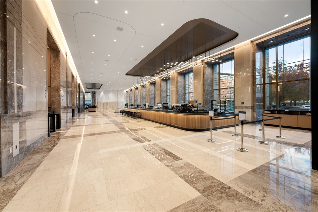 88 Kingston Street, Unit PH7C Boston, MA 02111 - Photo 28 of 31 a lobby with furniture and floor to ceiling window