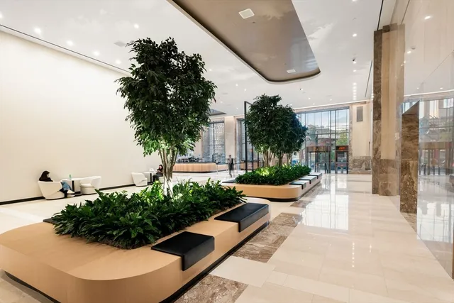 a view of a lobby with a garden and plants