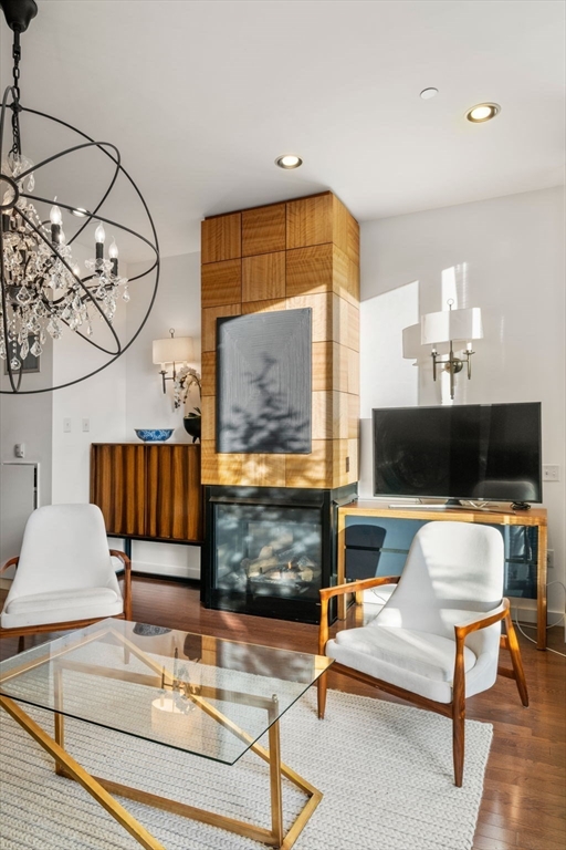 88 Kingston Street, Unit PH7C Boston, MA 02111 - Photo 3 of 31 a living room with furniture and a fireplace