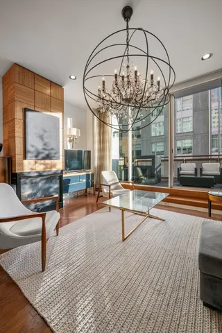 a living room with furniture and a chandelier