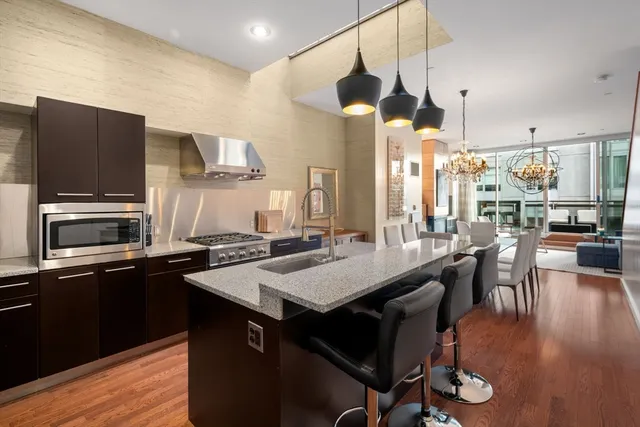 a kitchen with a table chairs refrigerator and cabinets