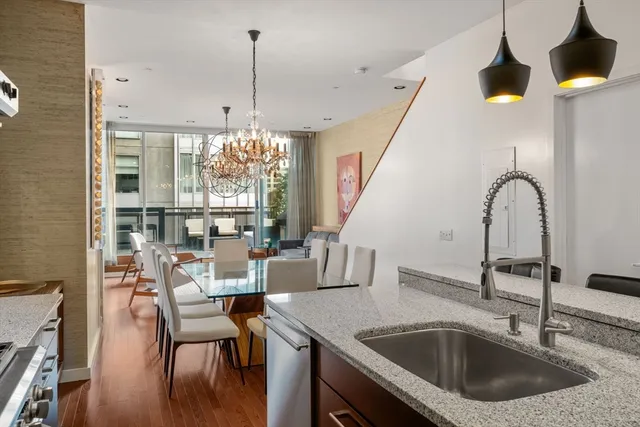 a kitchen with a table chairs and a chandelier