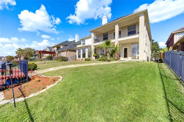 an aerial view of a house with garden space and street view