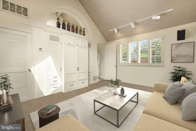 a living room with furniture and next to a window