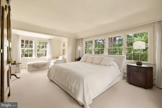 a bedroom with a bed and glass window