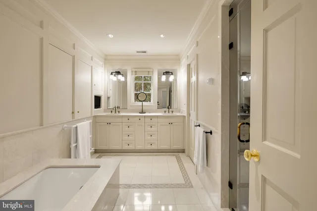 a bathroom with a double vanity sink mirror and shower