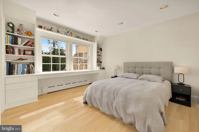 a spacious bedroom with a bed and a large window