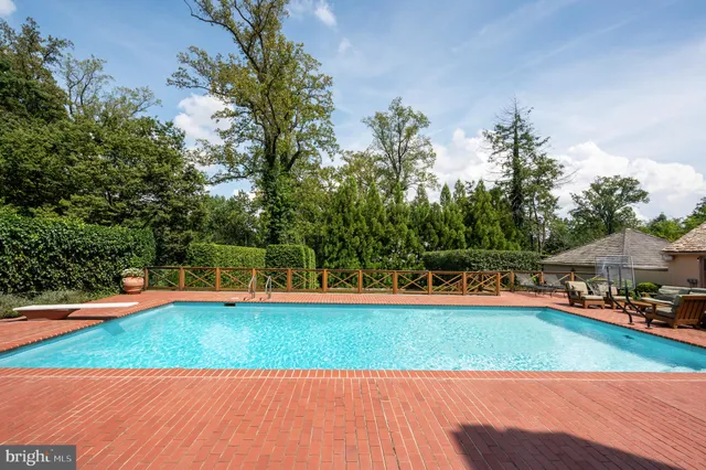 a view of a swimming pool with an outdoor space and seating area