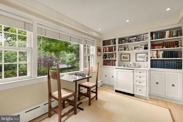 a view of a workspace with furniture and a window