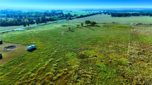 a view of a field with an ocean