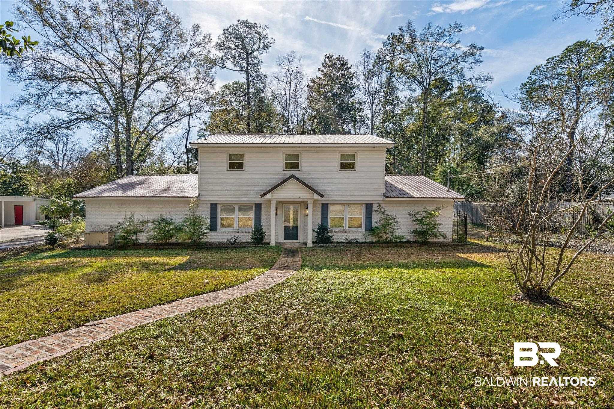 3933 Radnor Avenue Mobile, AL 36608 - Photo 33 of 36 View of front of property featuring a front lawn, a metal roof, and brick siding