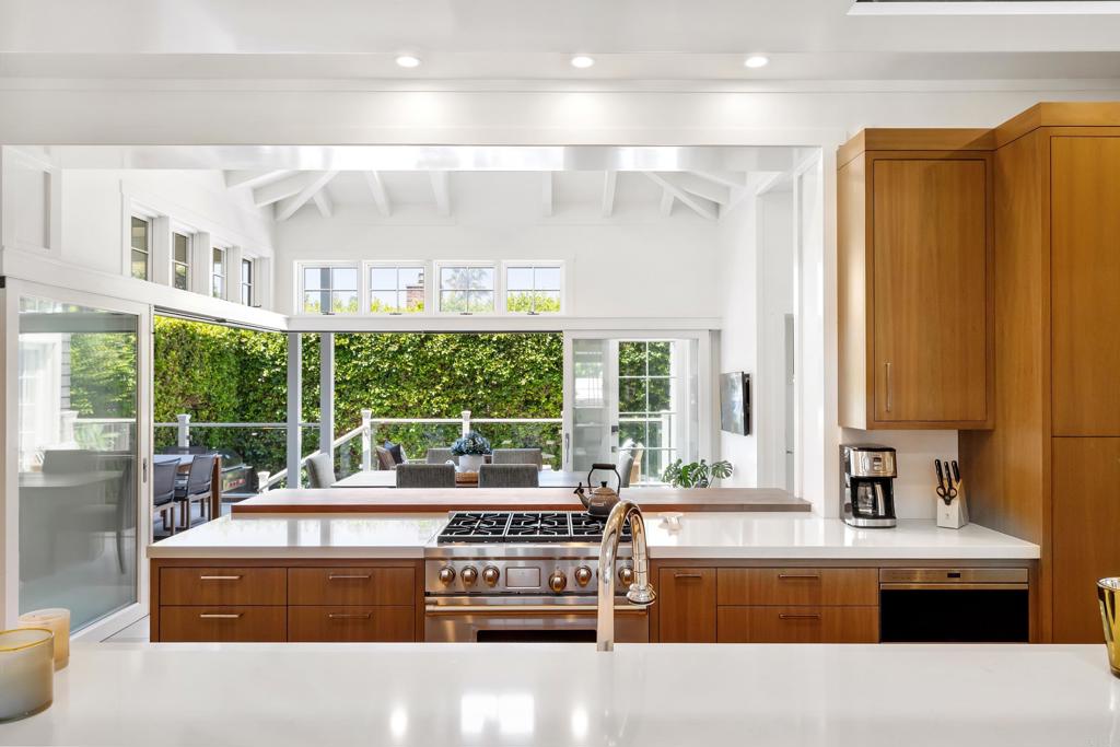 236 24th Street Del Mar, CA 92014 - Photo 11 of 44 a kitchen with a stove a sink and a refrigerator