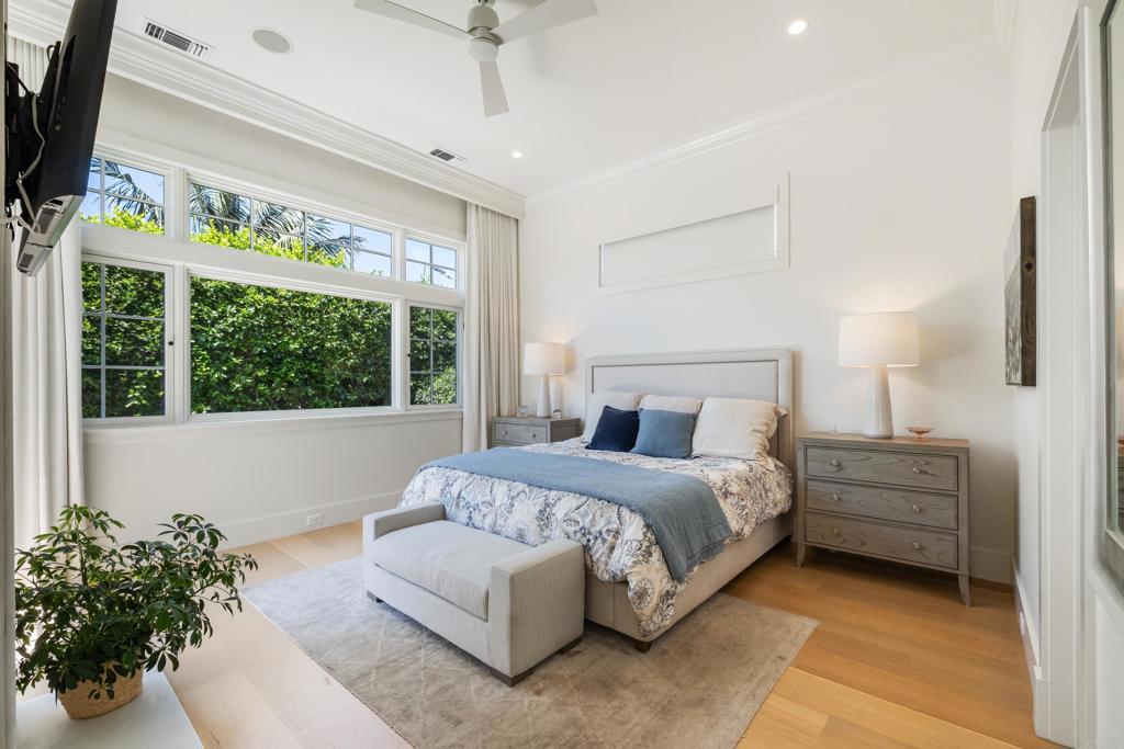 236 24th Street Del Mar, CA 92014 - Photo 18 of 44 a spacious bedroom with a bed table flowerpot and window