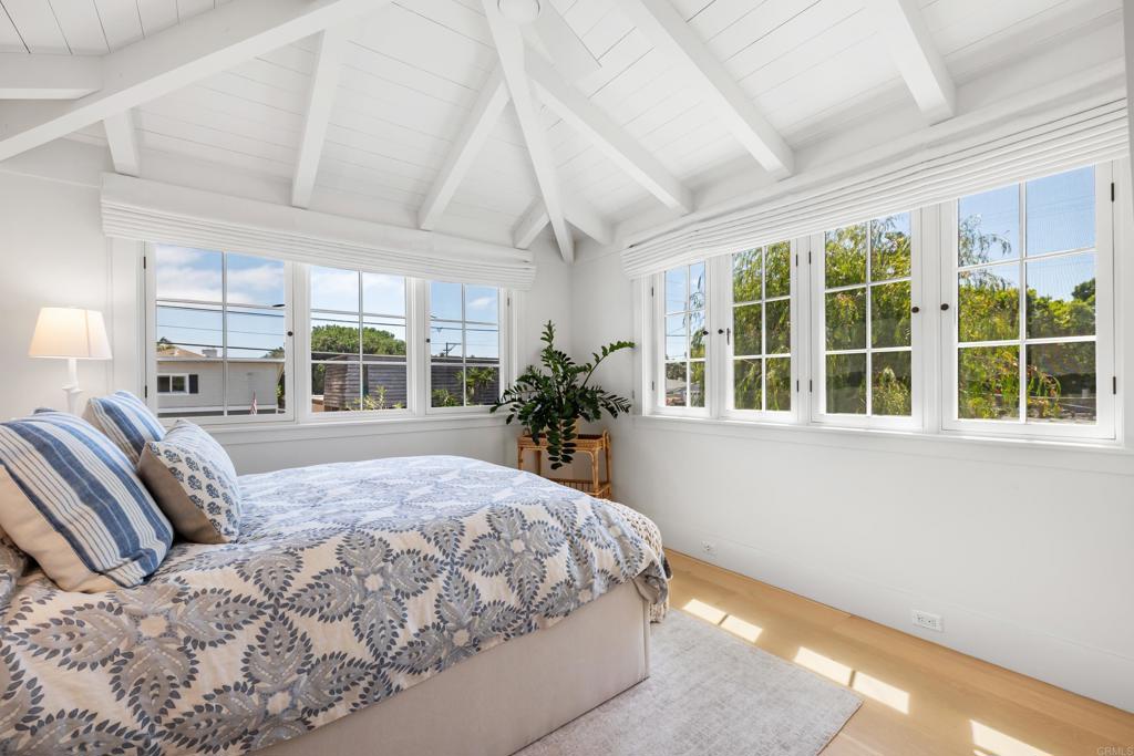 236 24th Street Del Mar, CA 92014 - Photo 22 of 44 a bedroom with a large bed and windows