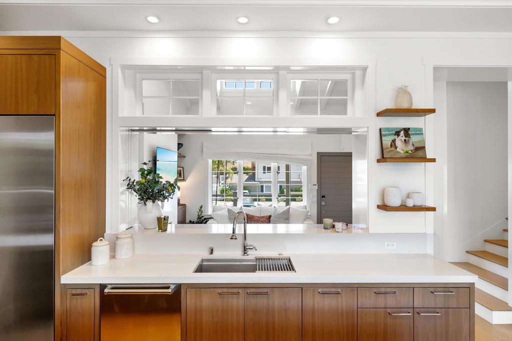 236 24th Street Del Mar, CA 92014 - Photo 7 of 44 a kitchen with kitchen island a counter top space a sink stainless steel appliances and cabinets