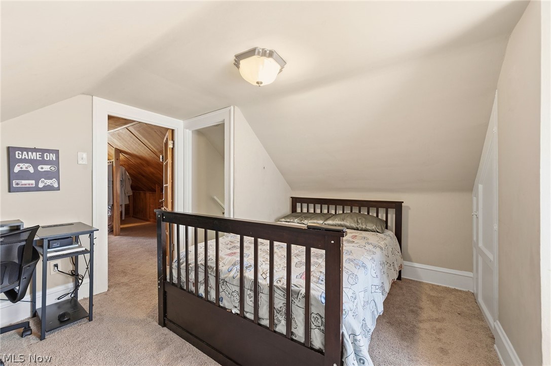 3386 Sylvanhurst Road Cleveland Heights, OH 44112 - Photo 33 of 46 Carpeted room with sloped ceilings and a flush-mount ceiling light fixture