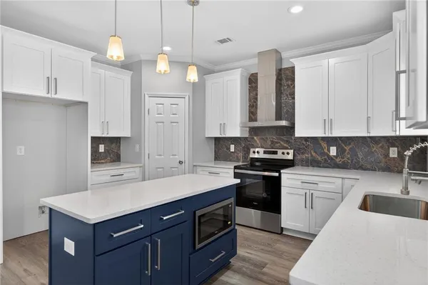 a kitchen with a sink stove and white cabinets