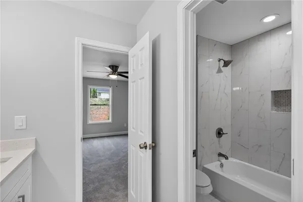 a bathroom with a bathtub shower sink and toilet