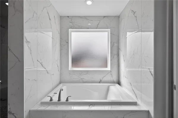 a white bath tub sitting next to a white sink
