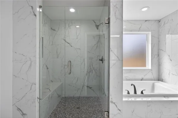 a bathroom with a shower and a sink