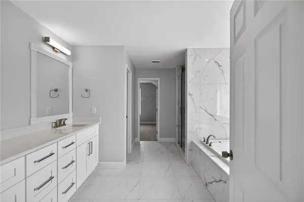 a spacious bathroom with a double vanity sink a mirror and a shower