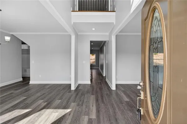 a view of a room with wooden floor stairs and a bathroom