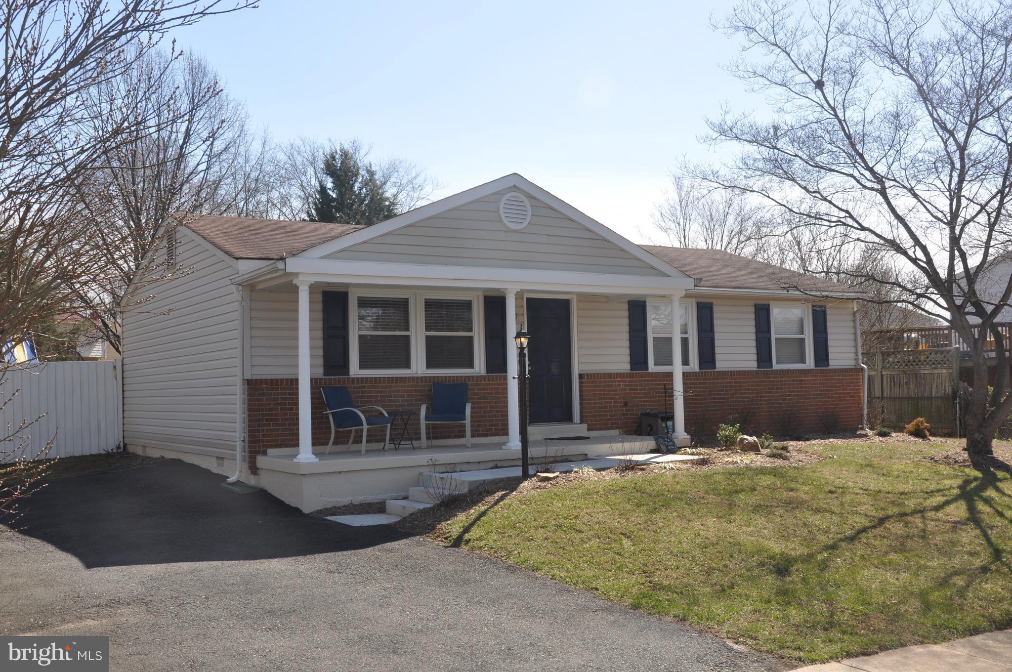 13847 Meadowbrook Road Woodbridge, VA 22193 - Photo 2 of 29 a front view of a house with a yard and garage