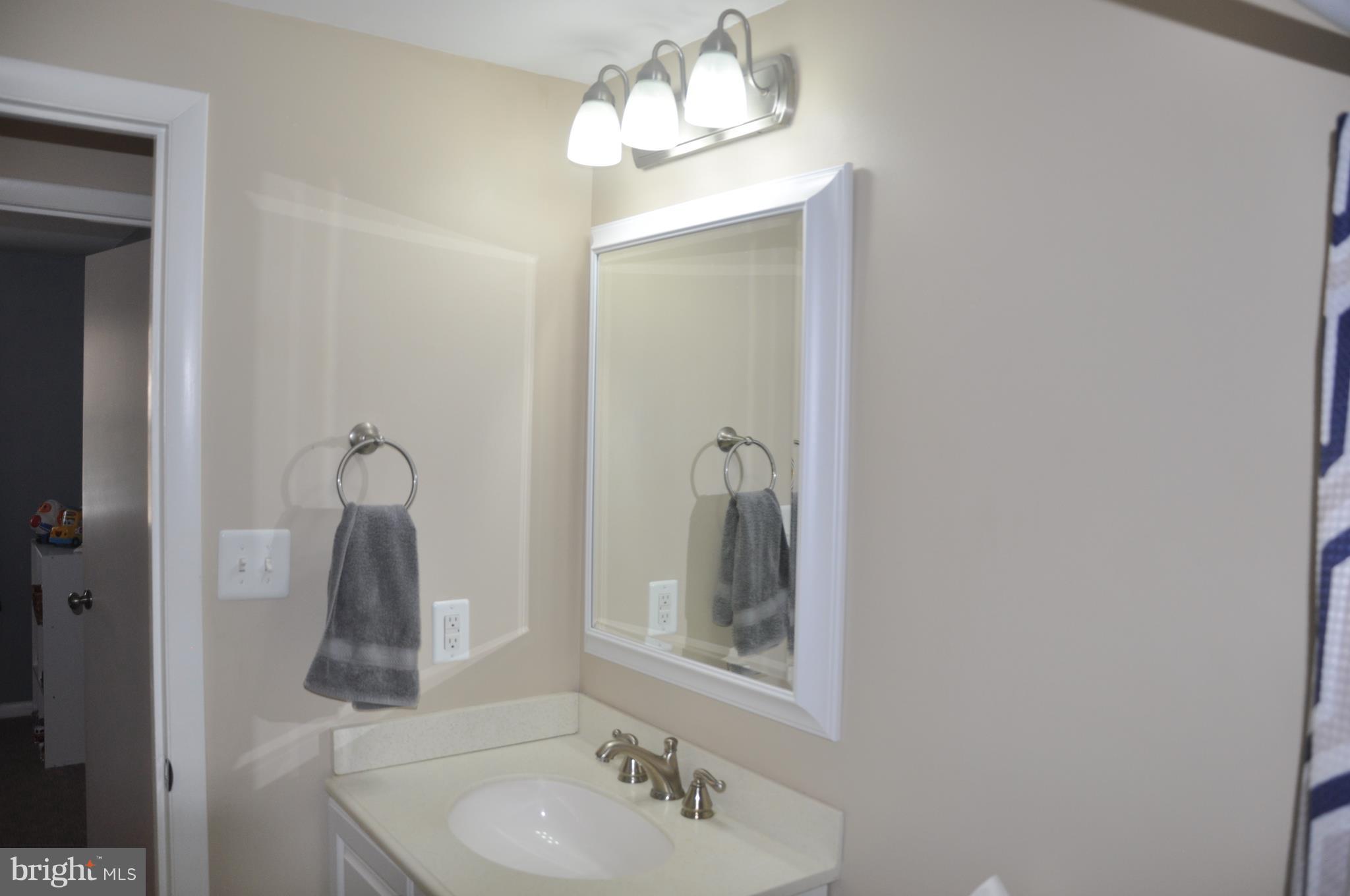 13847 Meadowbrook Road Woodbridge, VA 22193 - Photo 13 of 29 a bathroom with a sink a mirror and vanity