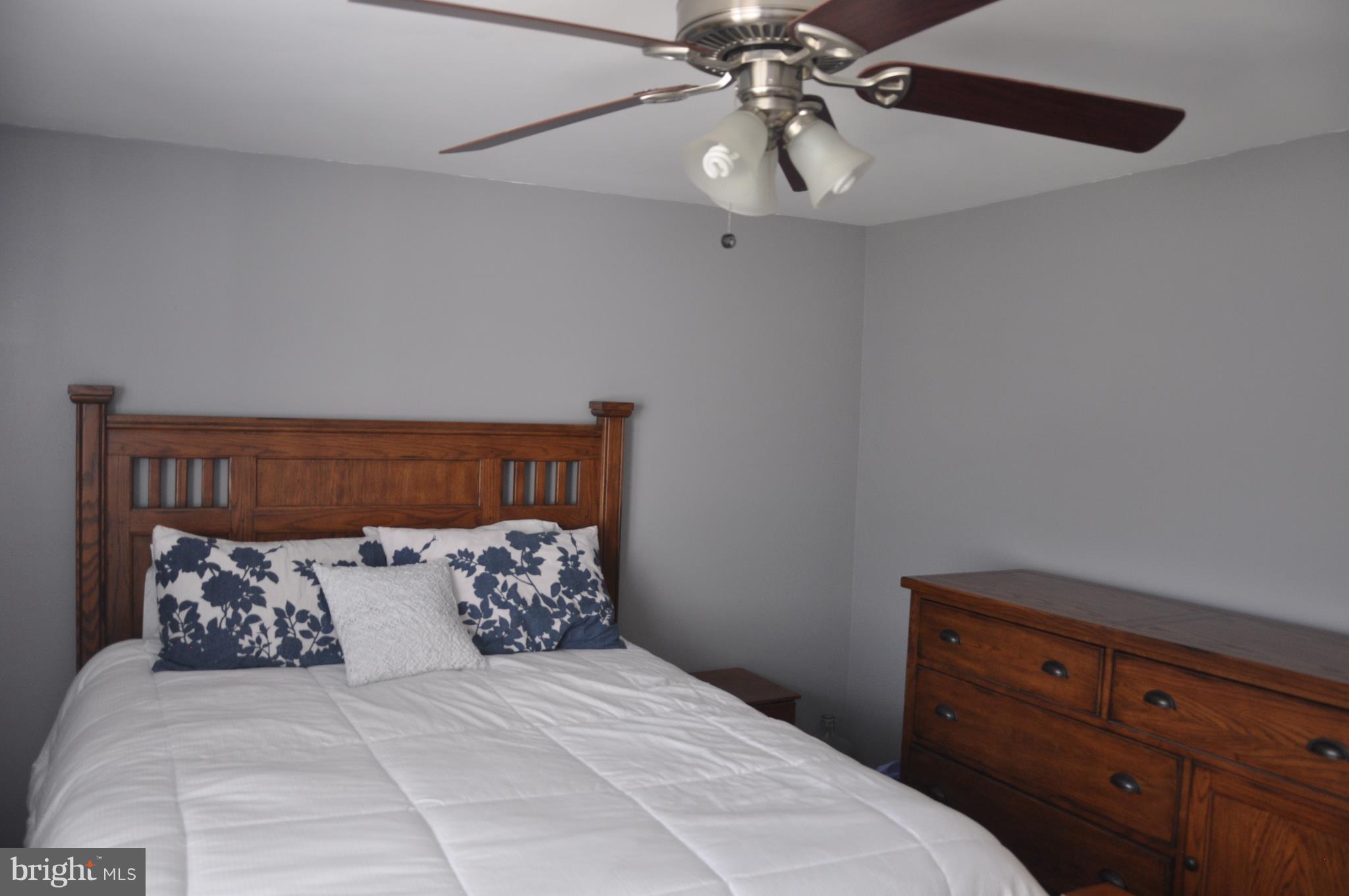 13847 Meadowbrook Road Woodbridge, VA 22193 - Photo 21 of 29 a bedroom with a bed and ceiling fan