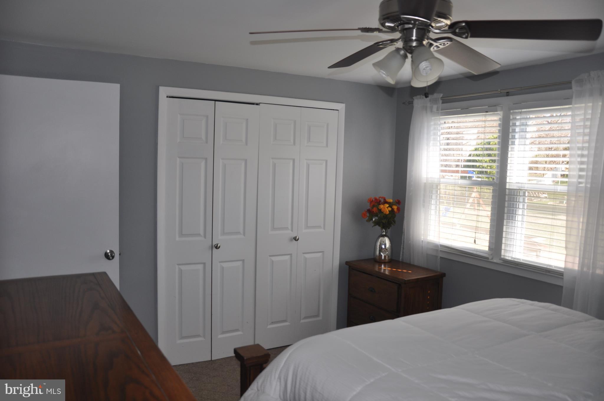 13847 Meadowbrook Road Woodbridge, VA 22193 - Photo 22 of 29 a bedroom with a bed and a chandelier