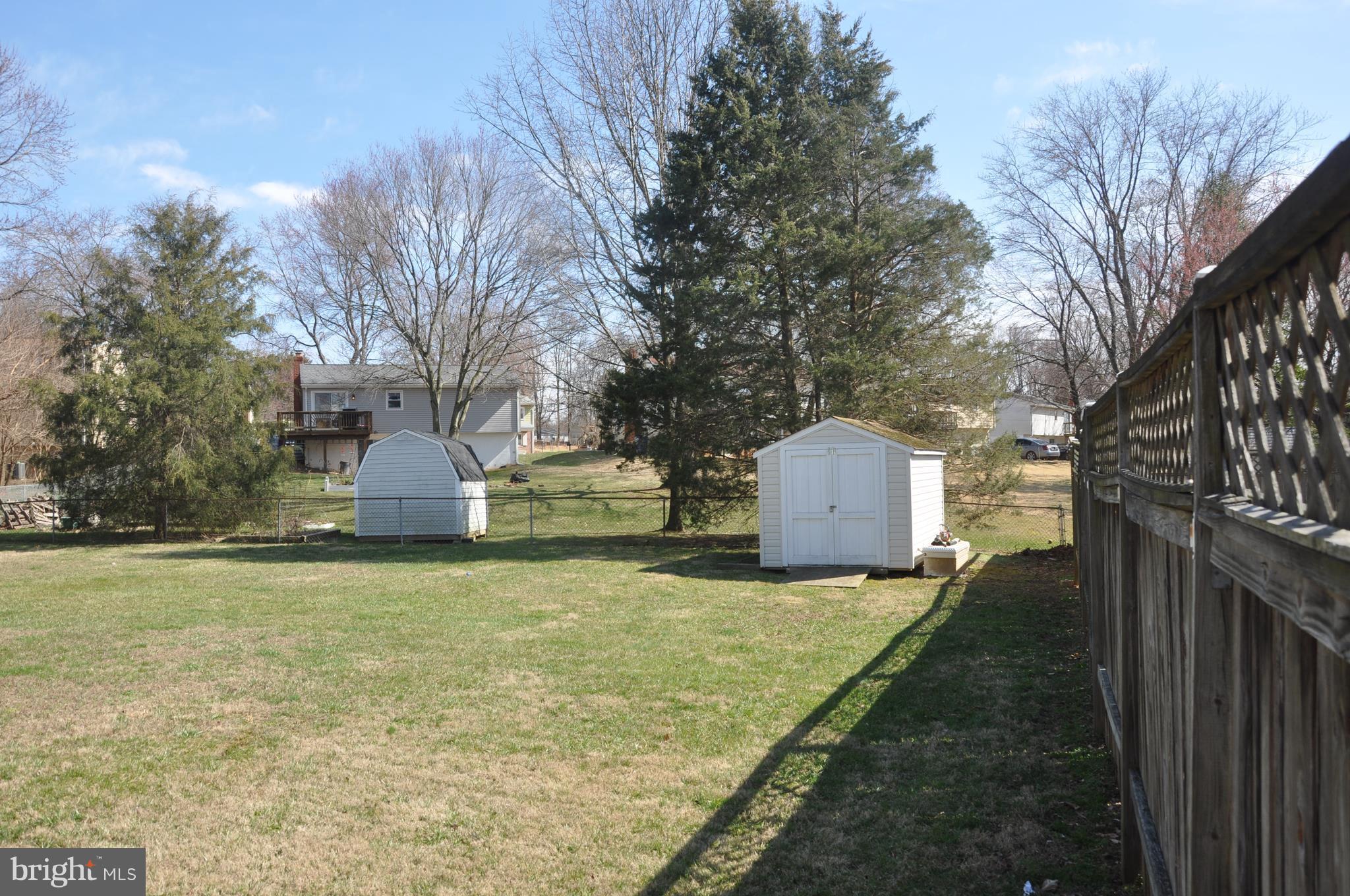 13847 Meadowbrook Road Woodbridge, VA 22193 - Photo 28 of 29 a view of a house with a yard and large trees
