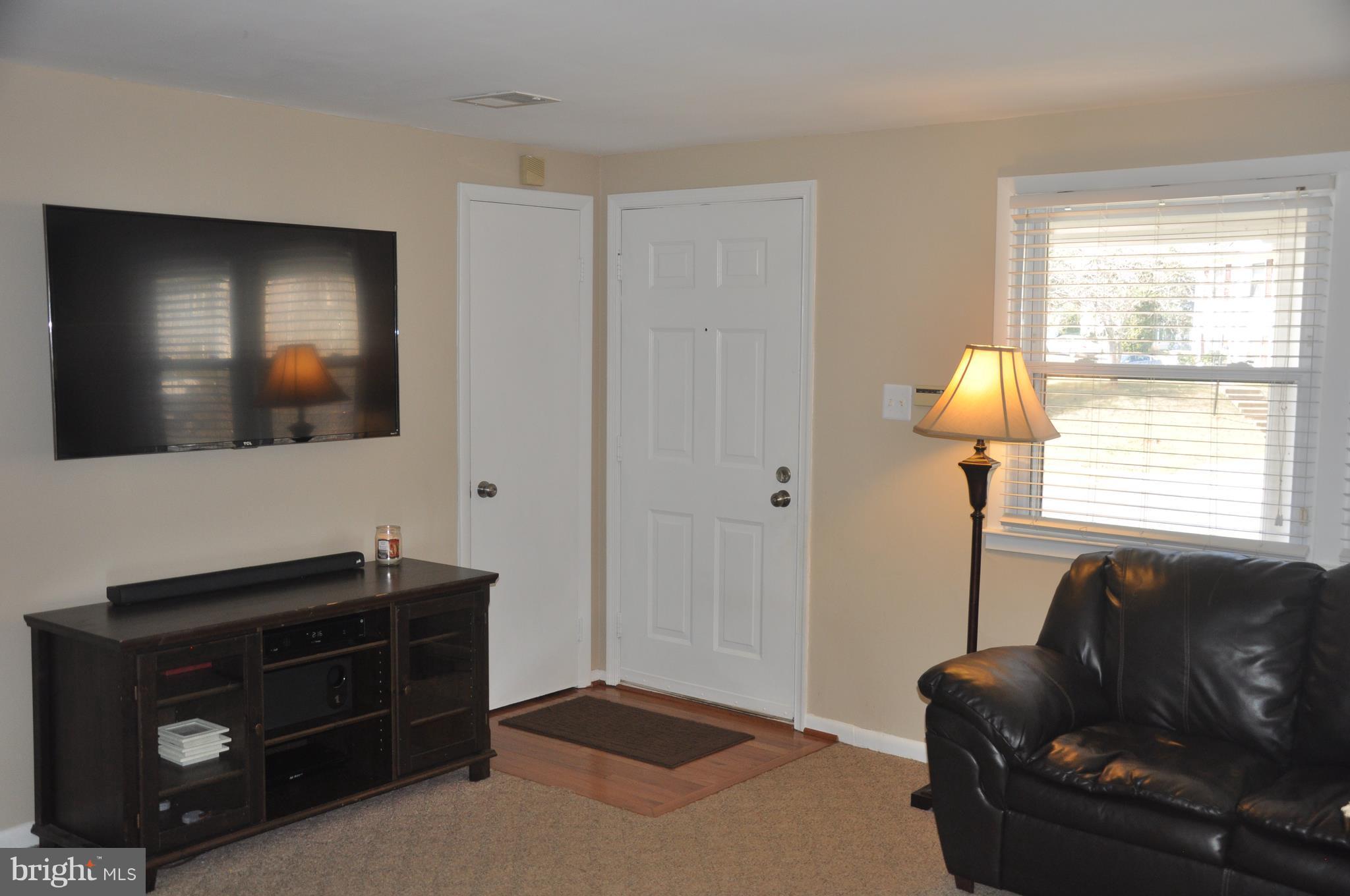 13847 Meadowbrook Road Woodbridge, VA 22193 - Photo 5 of 29 a living room with furniture and a flat screen tv