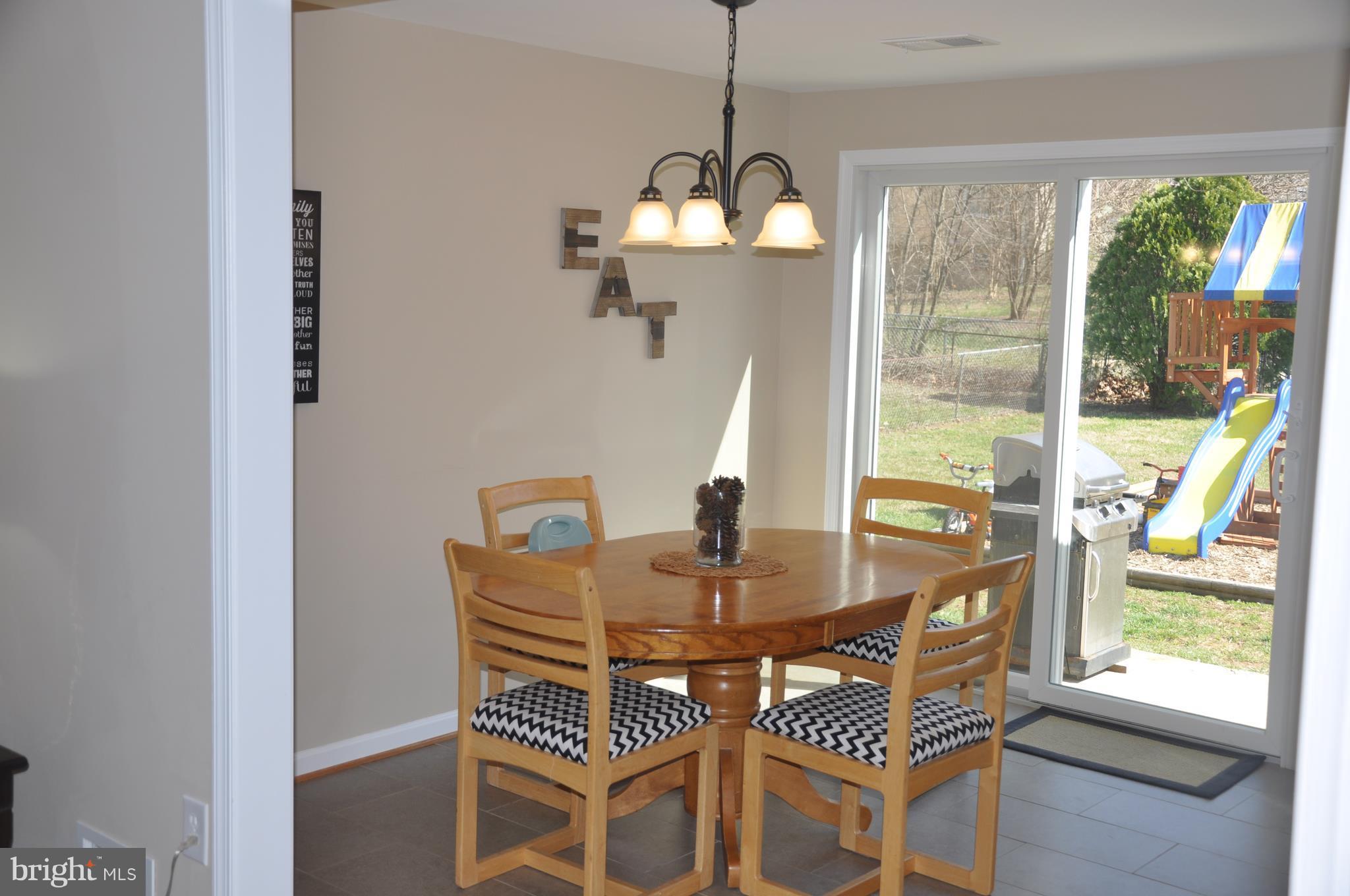 13847 Meadowbrook Road Woodbridge, VA 22193 - Photo 6 of 29 a view of a dining room with furniture wooden floor and a chandelier