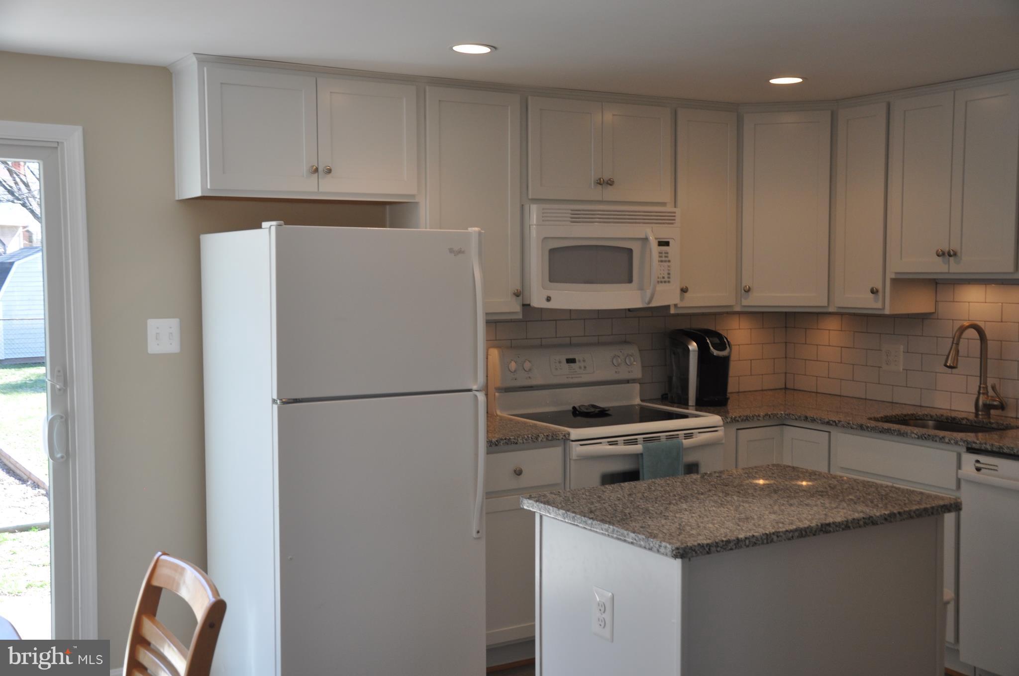 13847 Meadowbrook Road Woodbridge, VA 22193 - Photo 7 of 29 a kitchen with appliances a sink and cabinets