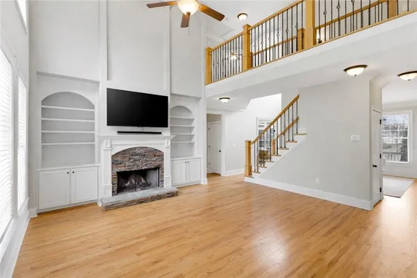 a living room with a fireplace and a flat screen tv