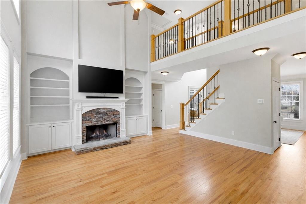 810 Ravenstone Way Canton, GA 30115 - Photo 15 of 51 a living room with a fireplace and a flat screen tv