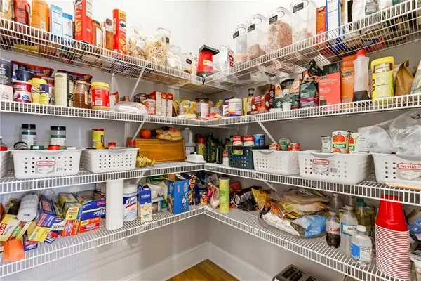 a store room with lots of clutter and refrigerator