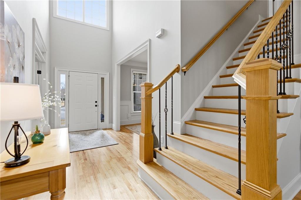 810 Ravenstone Way Canton, GA 30115 - Photo 24 of 51 a view of a hallway with wooden floor and staircase