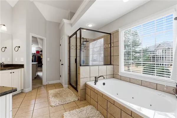 a bathroom with a bathtub and a shower