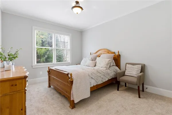 a bedroom with a bed chair and a window