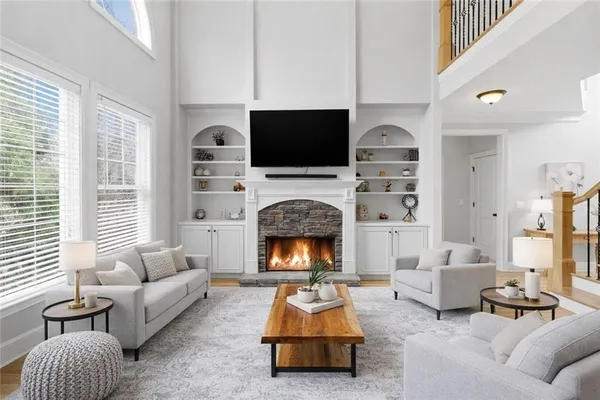a living room with furniture flat screen tv and a fireplace