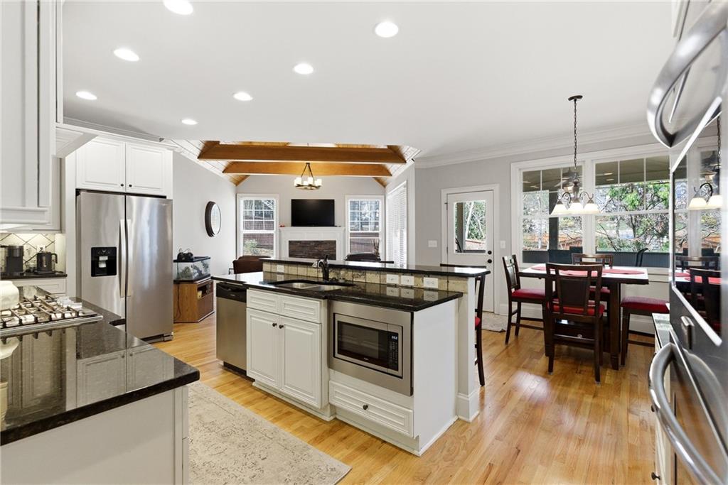 810 Ravenstone Way Canton, GA 30115 - Photo 6 of 51 a kitchen with stainless steel appliances kitchen island granite countertop a stove and a view of living room